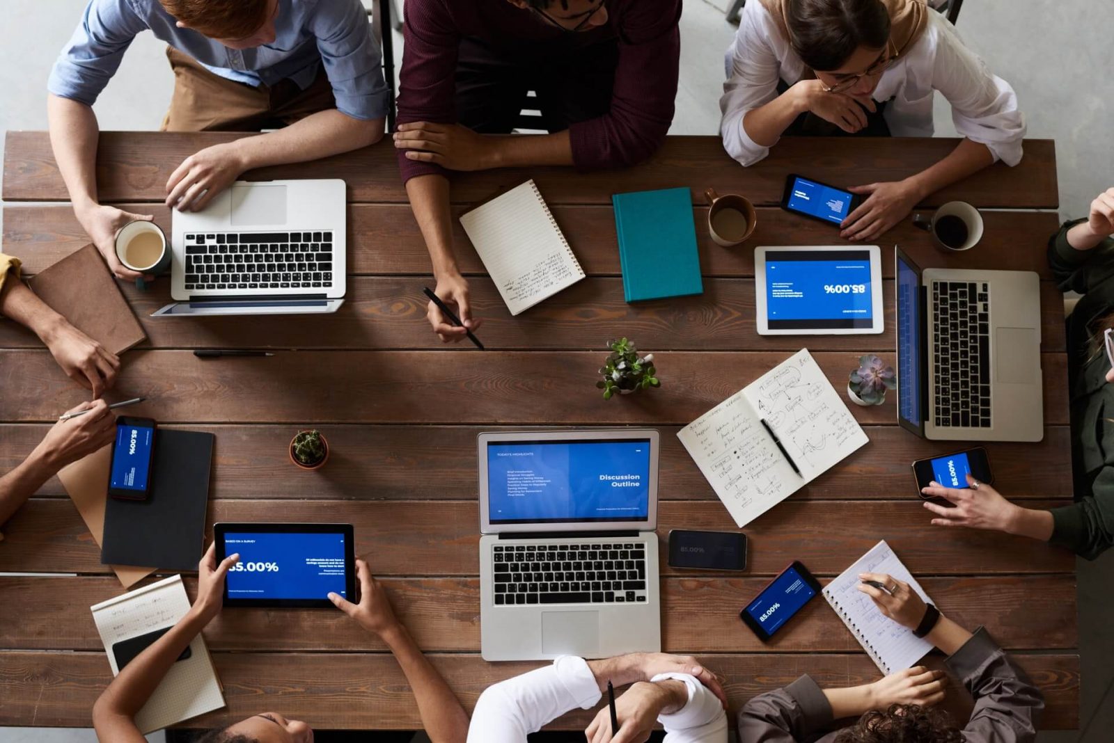 top-view-photo-of-people-near-wooden-table-3183150 (1) french business language course