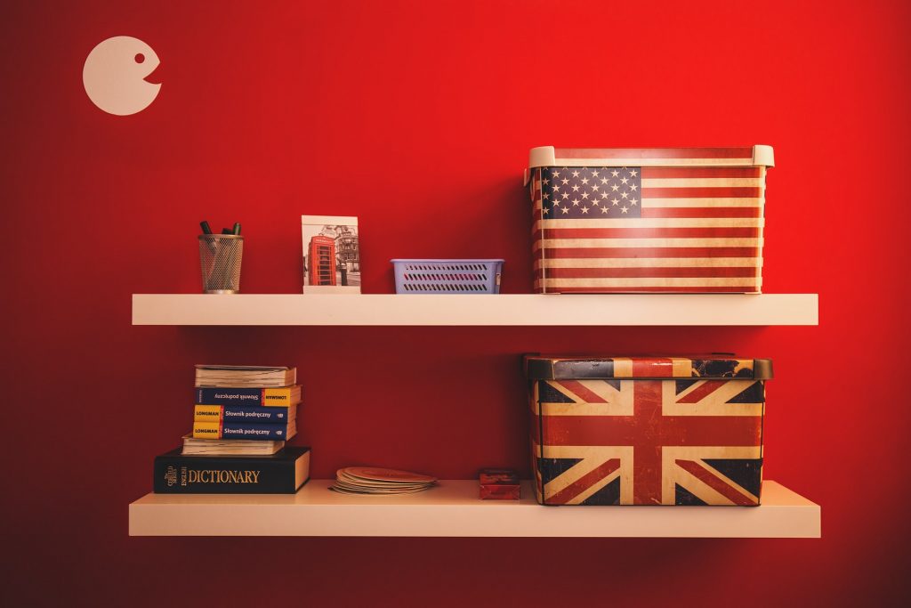 Things You Already Know about French - Elite French Tutoring - English and American flag with french learning books on the shelf