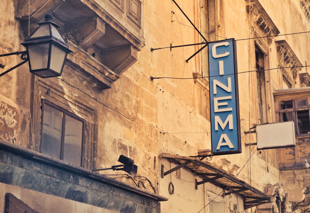 French cinema banner in French street - 6 Ways To Completely Immerse Yourself In French Culture
